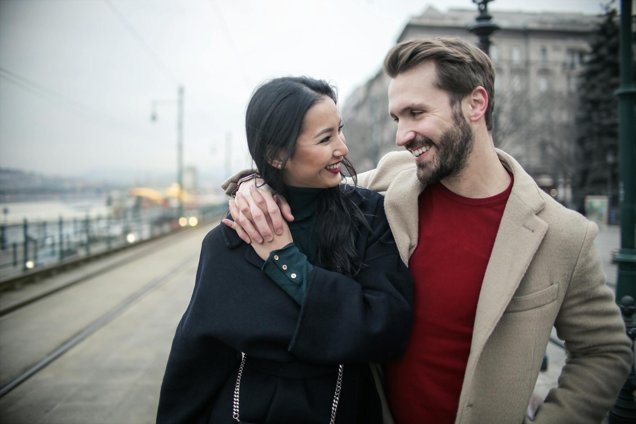 Man in Brown Coat Standing Beside Woman in Black Coat