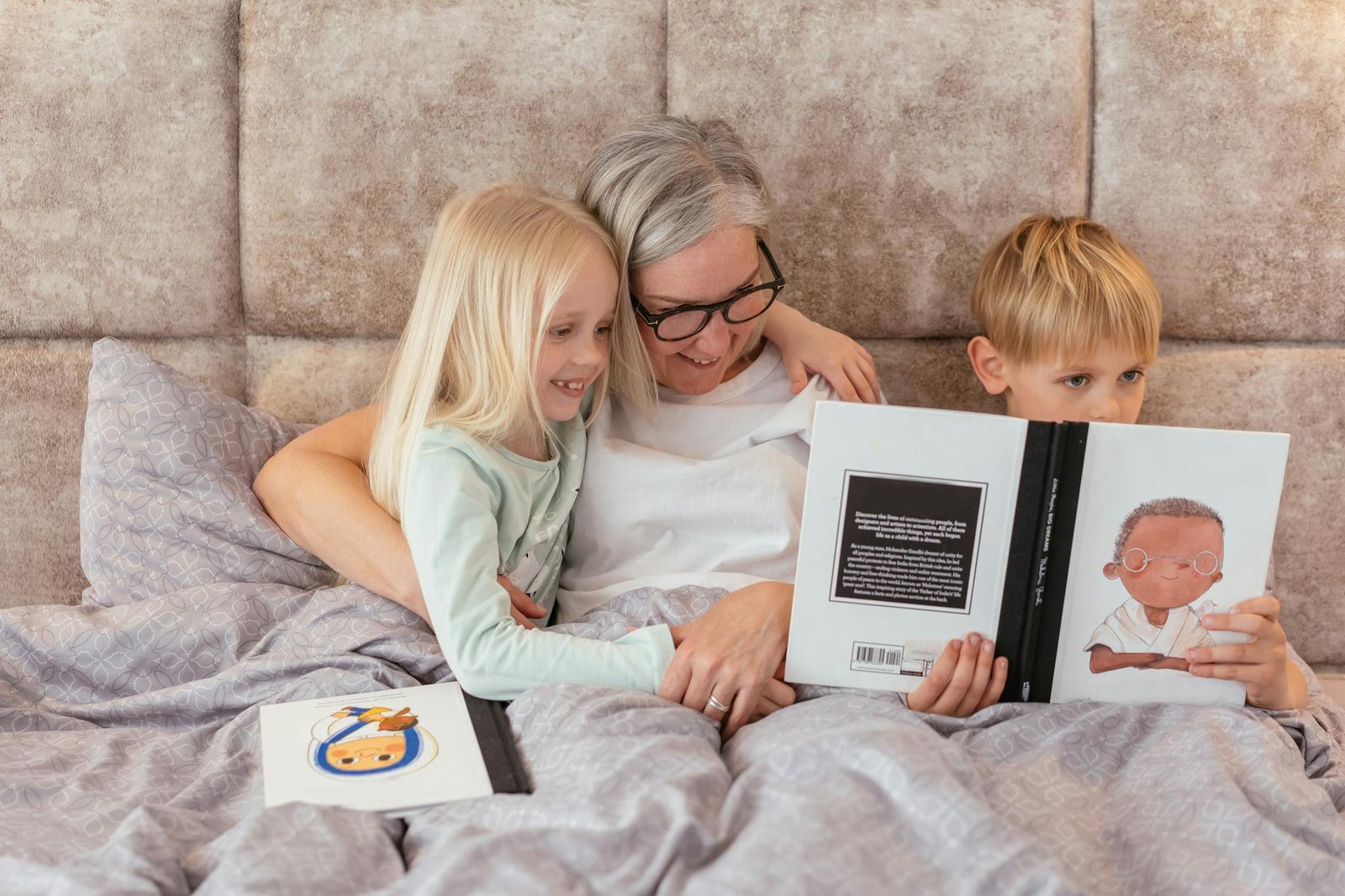 Woman with her Grandchildren Reading a Book